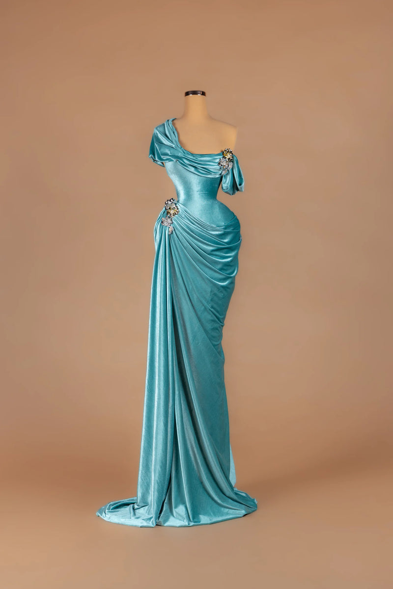 Sihëna Aegean Tide — teal asymmetric off-shoulder fitted gown with crystal accents on draped velvet.