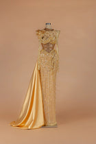 Sihëna Molten Regalia — gold high-neck long-sleeve column gown with a draped satin side train.