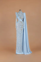 Sihëna Pearl Solstice — powder-blue high-neck long-sleeve column gown with draped pearl latticework.