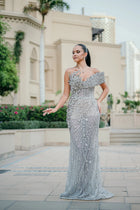 Sihëna Platinum Aigrette — silver sweetheart off-shoulder column gown with looping crystal chains and teardrop stones.